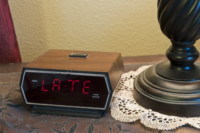 Old-fashioned alarm clock showing LA-TE as the time. cc by-nd 2.0 Evan Sharboneau